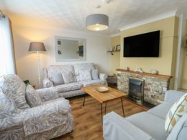 A living room with sofas and a coffee table at Glasfryn in Holyhead