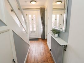 A hallway with front door and shelf at Glasfryn in Holyhead