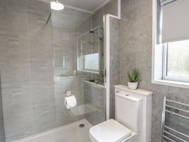 A bathroom with a shower, toilet, and sink at Glasfryn in Holyhead