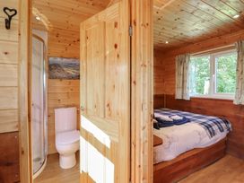 A bedroom with a shower and toilet at Stag Lodge Pod Llanfair Caereinion