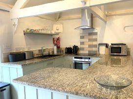 A kitchen with appliances and a countertop at Lavender Barn Crantock