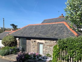 A house with flowers and chairs outside at Lavender Barn in Crantock