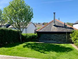 A garden with a tree and building at Lavender Barn Crantock