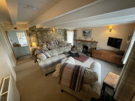 A living room with a sofa and television at Penllain in Newport, Pembrokeshire