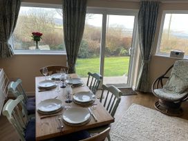 A dining room with a table set for a meal at Penllain Newport, Pembrokeshire