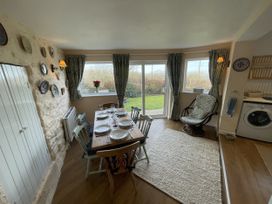 A dining area with a table and chairs at Penllain, Newport, Pembrokeshire