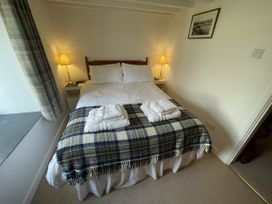 A bedroom with a double bed and towels at Penllain in Newport, Pembrokeshire