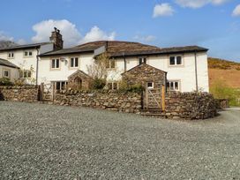 A house with stone wall and gated entrance at One Town End, Mungrisdale, Mosedale