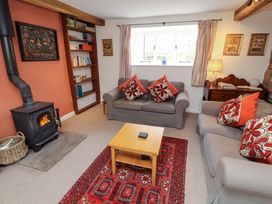 A living room with a sofa and fireplace at One Town End in Mungrisdale, Mosedale