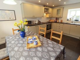 A kitchen with a table and chairs at One Town End in Mungrisdale, Mosedale