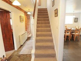 A hallway with stairs and a dining area at One Town End in Mungrisdale, Mosedale