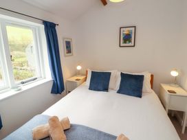 A bedroom with a bed and bedside tables at One Town End, Mungrisdale, Mosedale