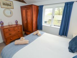 A bedroom with a bed, wardrobe and dresser at One Town End, Mungrisdale, Mosedale