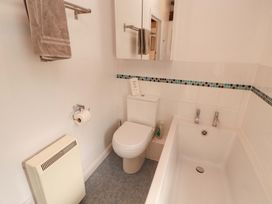 A bathroom with a toilet, bathtub, and sink at One Town End, Mungrisdale, Mosedale