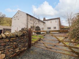 An outdoor view of a house with a gate at One Town End in Mungrisdale, Mosedale