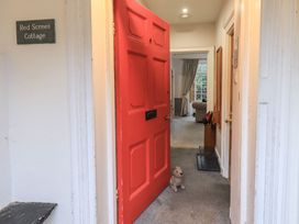A hallway with a red door and a dog toy at Red Screes Cottage in Ambleside