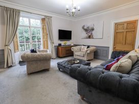 A living room with sofas and a television at Red Screes in Ambleside