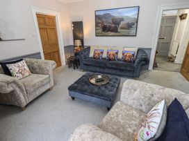 A living room with two sofas, a coffee table and a painting at Red Screes in Ambleside