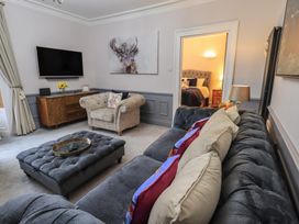 A living room with a sofa and television at Red Screes in Ambleside