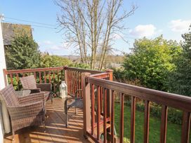 A balcony with chairs and a lantern at Red Screes in Ambleside