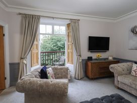 A living room with a sofa, chair, and television at Red Screes in Ambleside