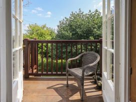 A balcony with a chair overlooking greenery at Red Screes in Ambleside