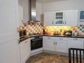 A kitchen with cabinets, stove, oven, and appliances at Red Screes in Ambleside