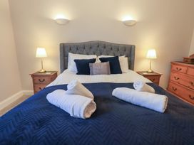 A bedroom with a bed and bedside lamps at Red Screes, Ambleside