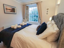 A bedroom with a bed and window at Red Screes in Ambleside