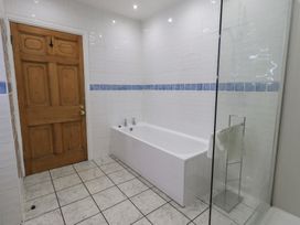 A bathroom with a bathtub and a shower at Red Screes in Ambleside