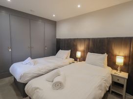 A bedroom with two single beds and lamps at Red Screes in Ambleside