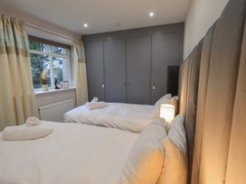 A bedroom with two beds and a window at Red Screes in Ambleside