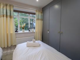 A bedroom with a bed and window at Red Screes in Ambleside
