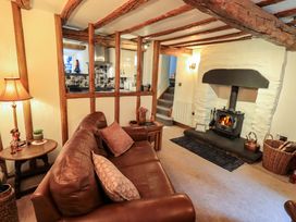 A living room with a sofa and fireplace at Fellside Cottage Bowness-On-Windermere
