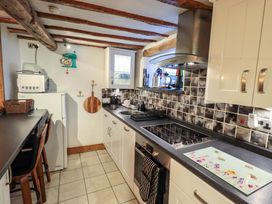 A kitchen with a countertop and appliances at Fellside Cottage in Bowness-On-Windermere