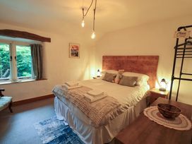 A bedroom with a bed and bedside tables at Fellside Cottage in Bowness-On-Windermere