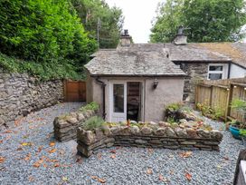 An outdoor area with a cottage and gravel path at Fellside Cottage Bowness-On-Windermere