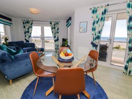 A living room with a table and chairs at Ocean View Apartment in Colwyn Bay
