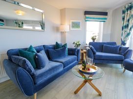 A living room with a sofa and coffee table at Ocean View Apartment in Colwyn Bay