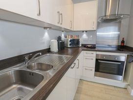 A kitchen with a sink and oven at Ocean View Apartment in Colwyn Bay