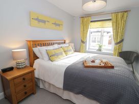 A bedroom with a bed and nightstand at Ocean View Apartment in Colwyn Bay