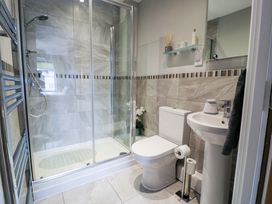 A bathroom with a shower, toilet and sink at Ocean View Apartment in Colwyn Bay
