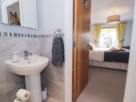 A bathroom with a sink and mirror at Ocean View Apartment in Colwyn Bay