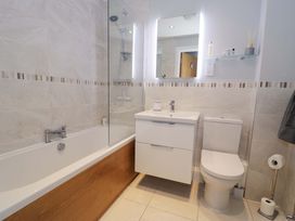 A bathroom with a bathtub and sink at Ocean View Apartment Colwyn Bay
