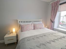 A bedroom with a bed and bedside table at Ocean View Apartment in Colwyn Bay