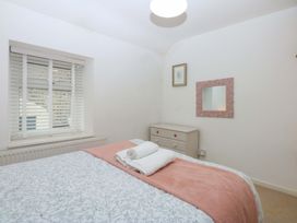 A bedroom with a bed and dresser at 27 Kingshead Street Pwllheli