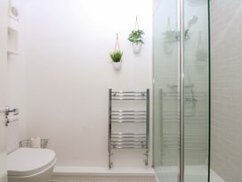 A bathroom with a shower and toilet at 27 Kingshead Street Pwllheli