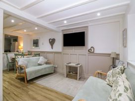 A living room with a sofa and television at 27 Kingshead Street Pwllheli