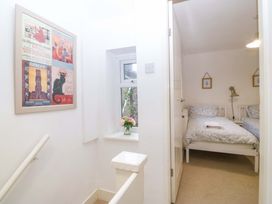 A bedroom with two beds and a window at 27 Kingshead Street Pwllheli