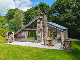A cabin with a deck and outdoor seating area at The Badger's Shack, Garnett Bridge, Longsleddale. Near Kendal